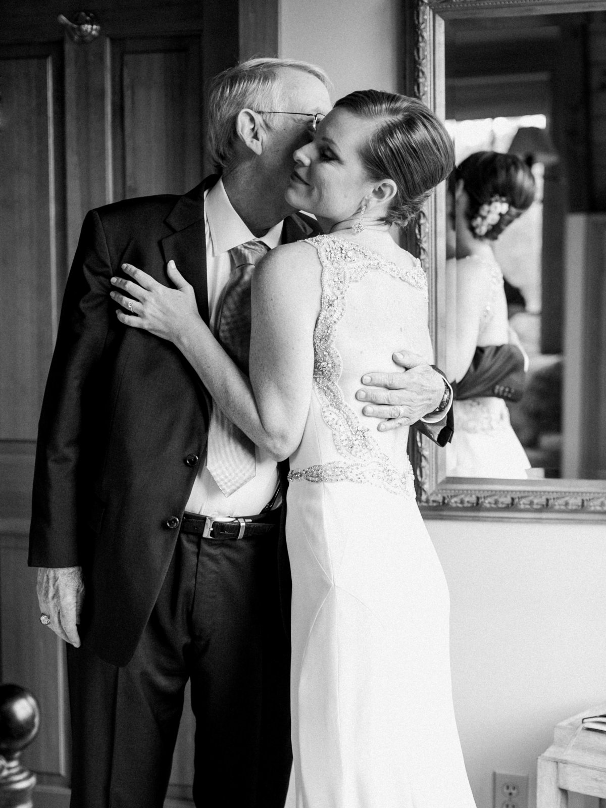 father of the bride kissing the bride's cheek