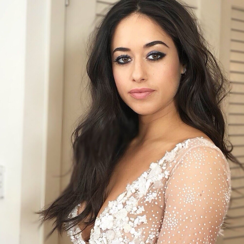 Jeanine Mason in a white dress with black eyeliner