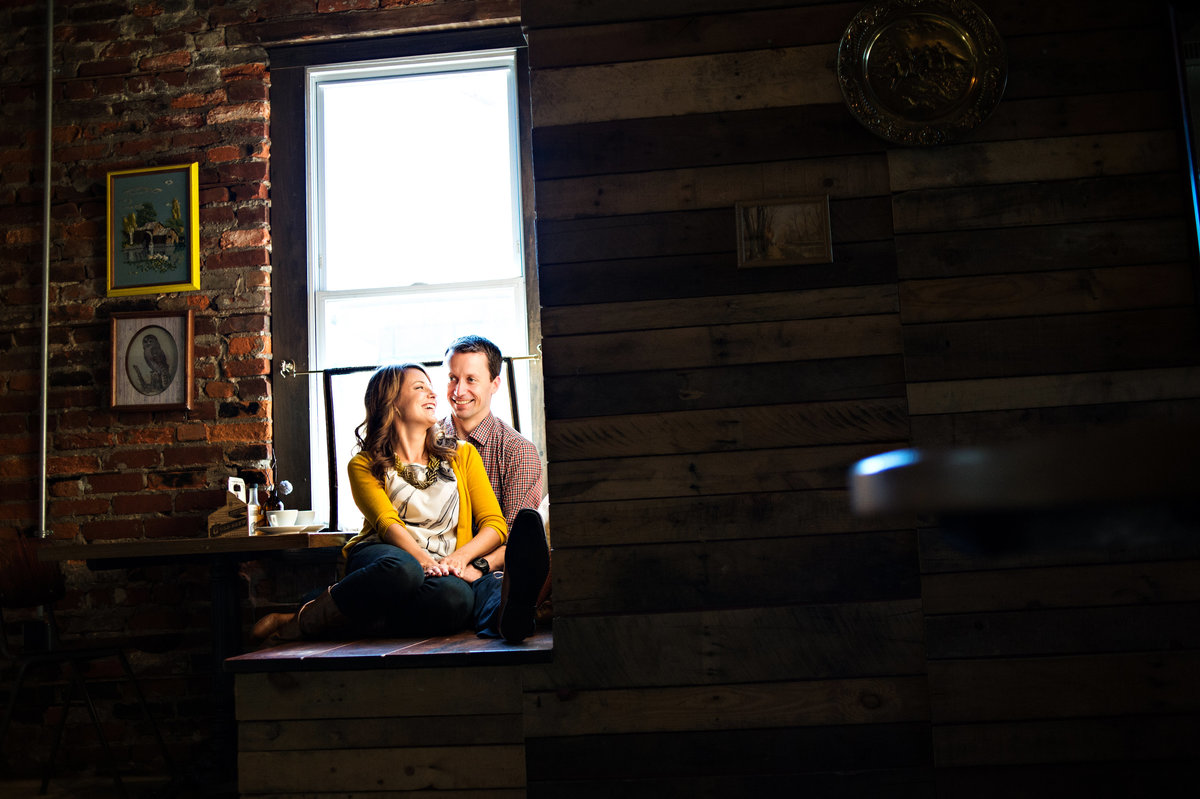 A couple sit in the window light at one shot coffee in northern liberties.