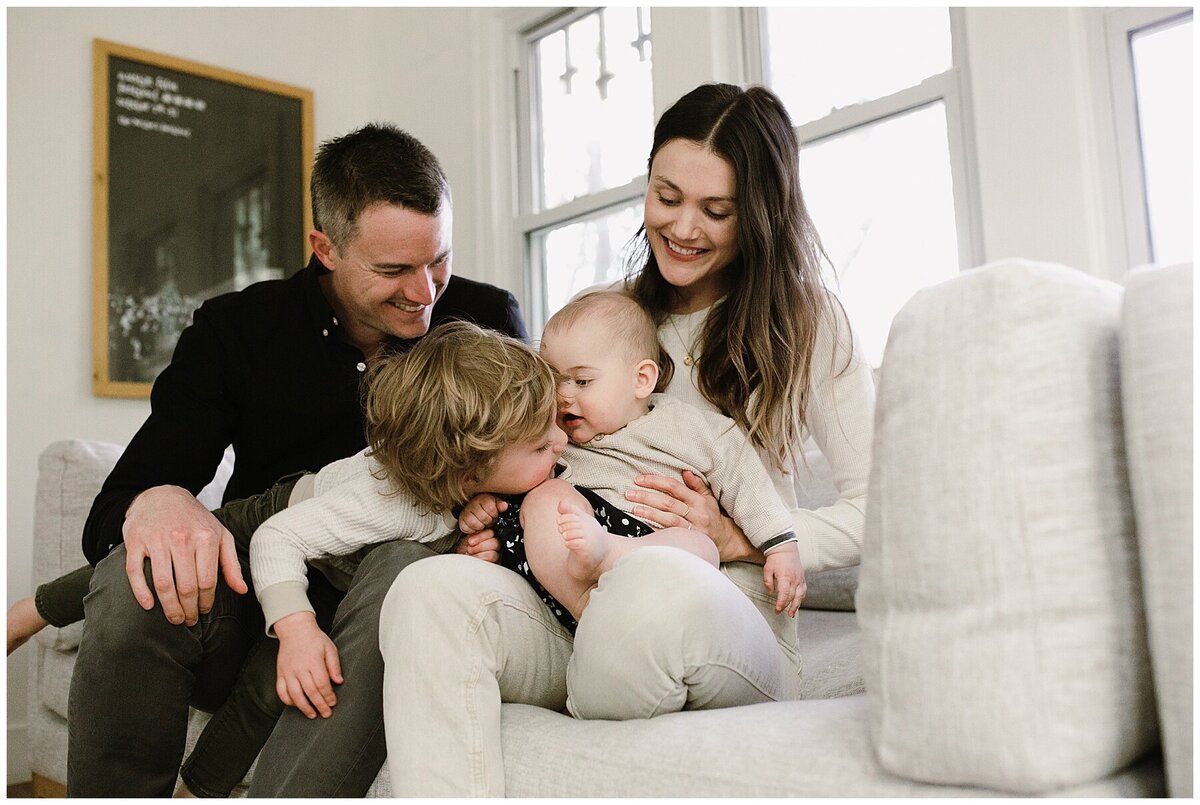 Mother and father with toddler and baby at sweet home family session in Austin by Amber Vickey Photography
