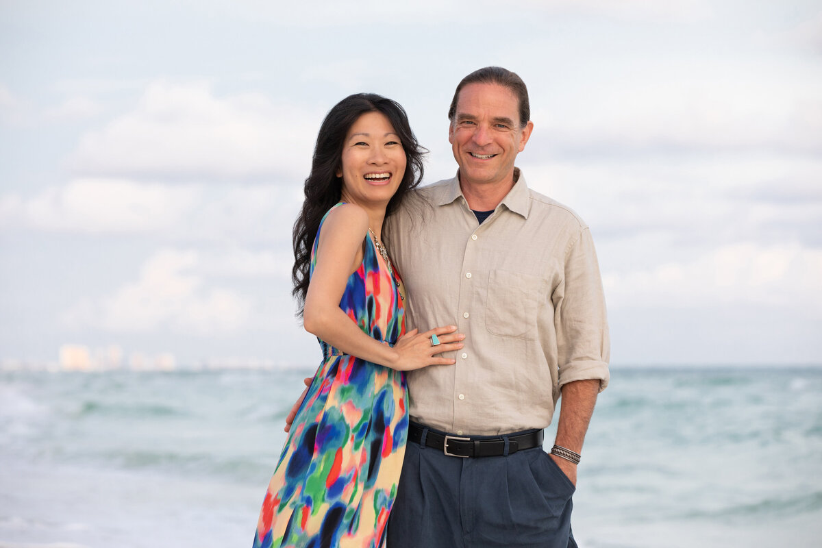 A couple with their arms around each other smiling