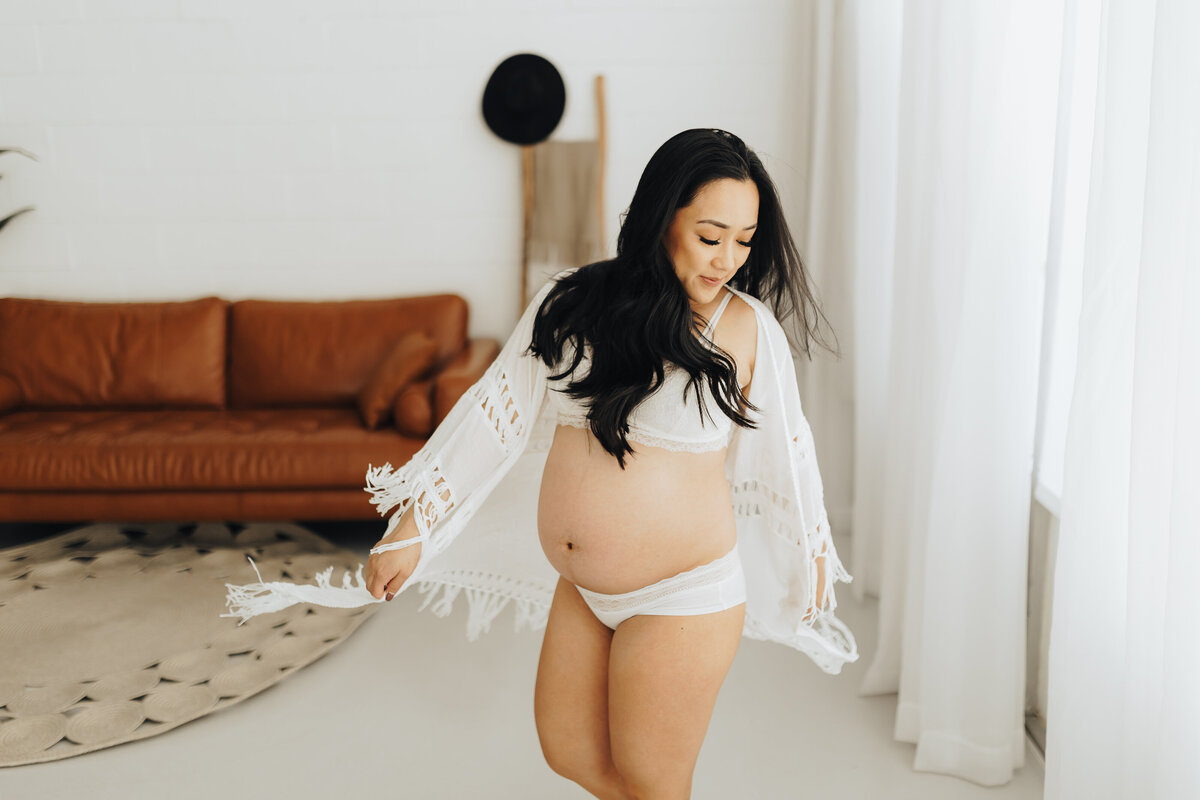 Mom Twirls around at a maternity session Emily Woodall Photography