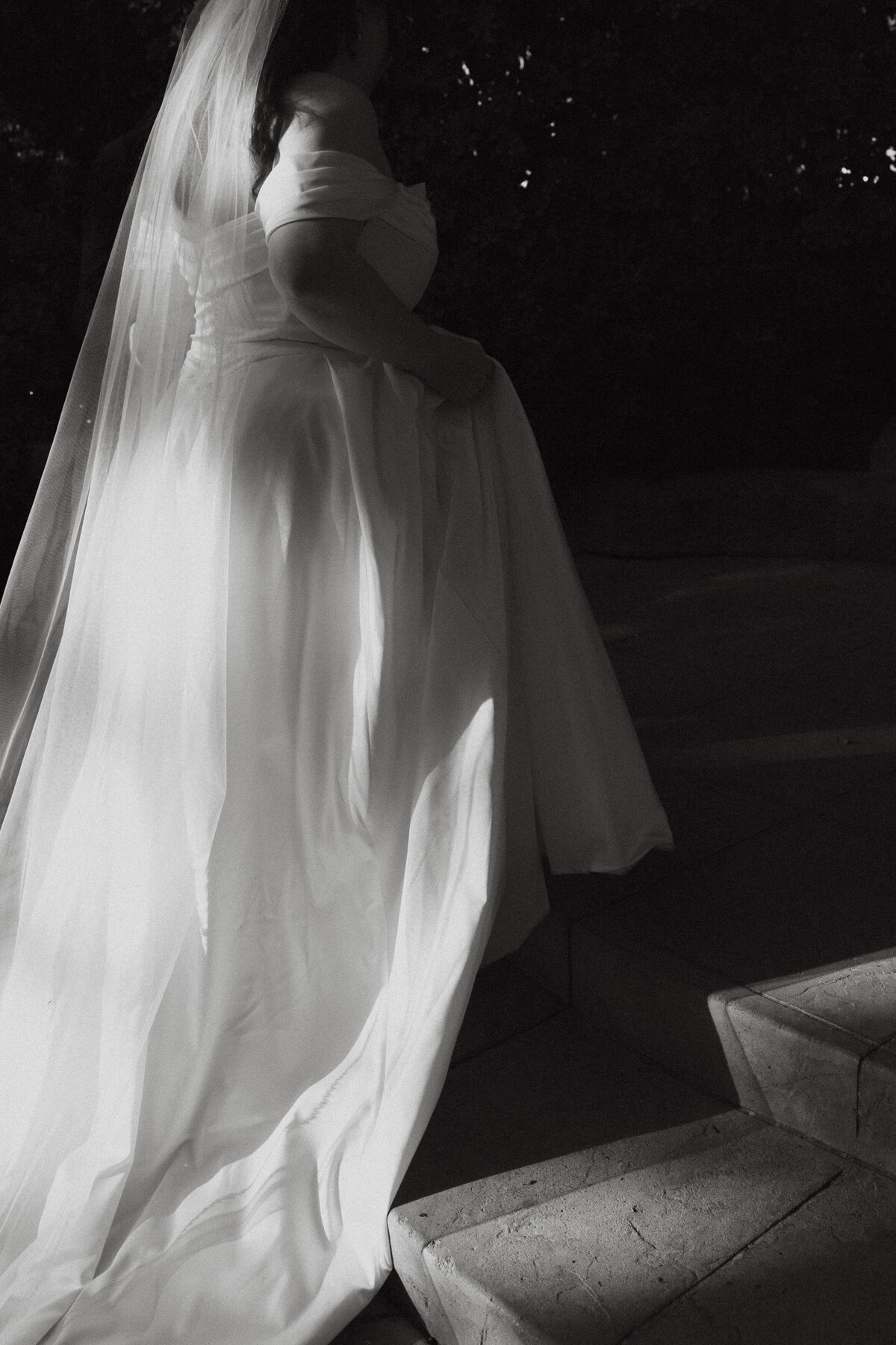Black and white photo of a person in a wedding dress 
