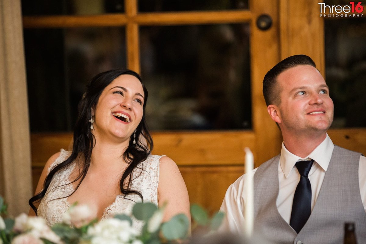 Bride and Groom laugh during the toast