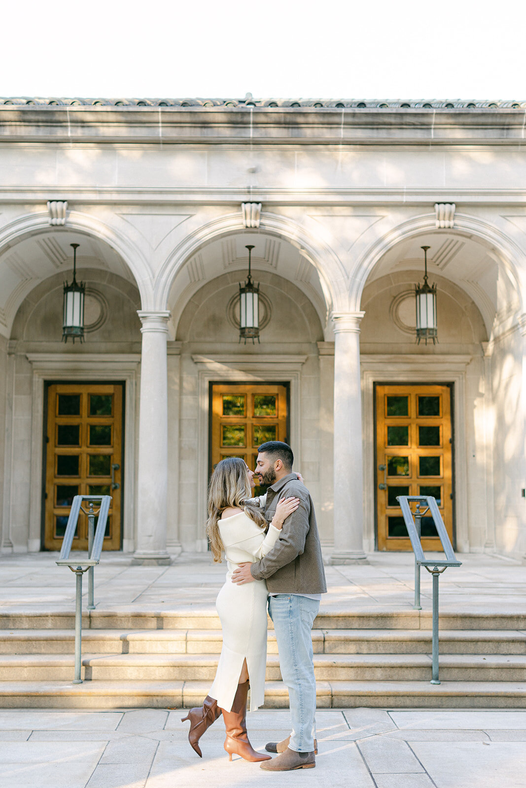 Couple embracing during golden hour engagement session in a Pittsburgh park