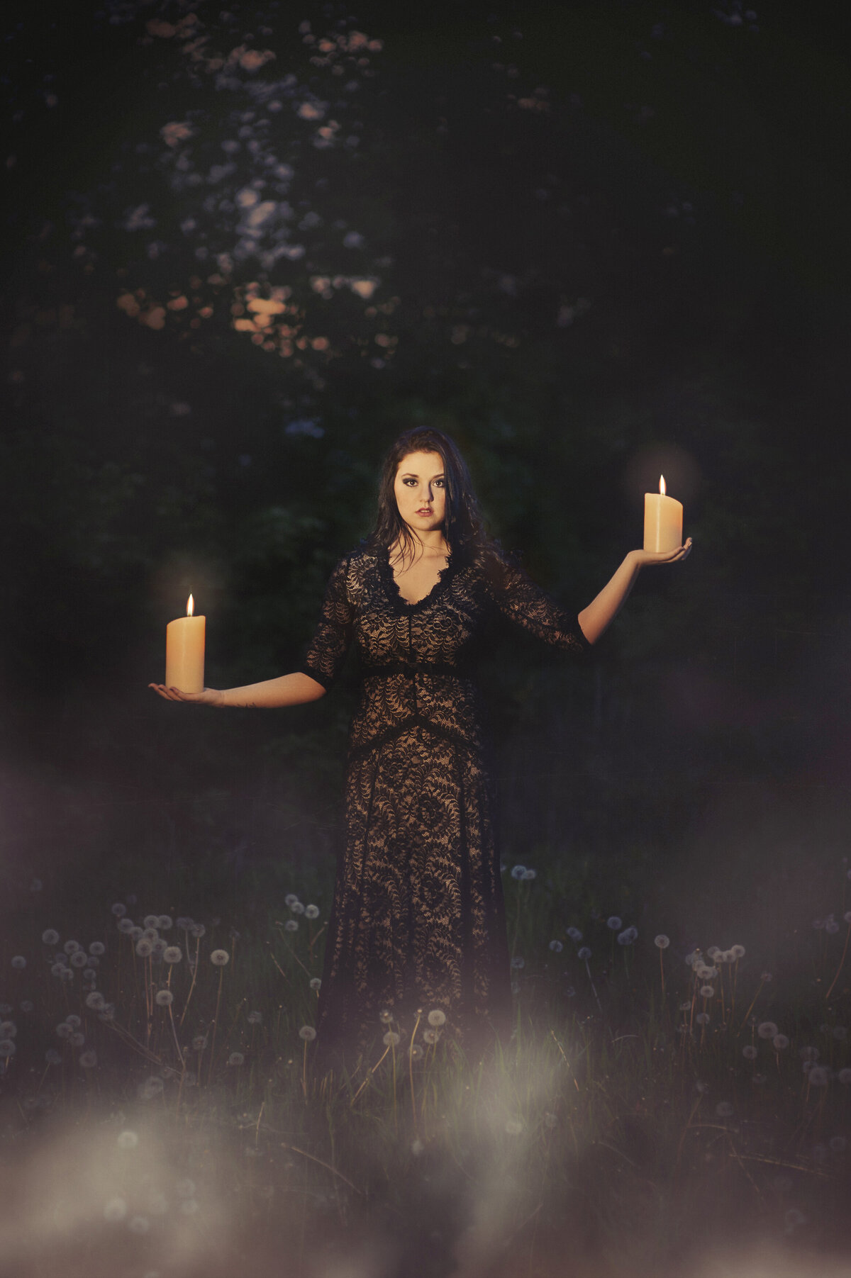 senior photo of girl with candles  and fog at night