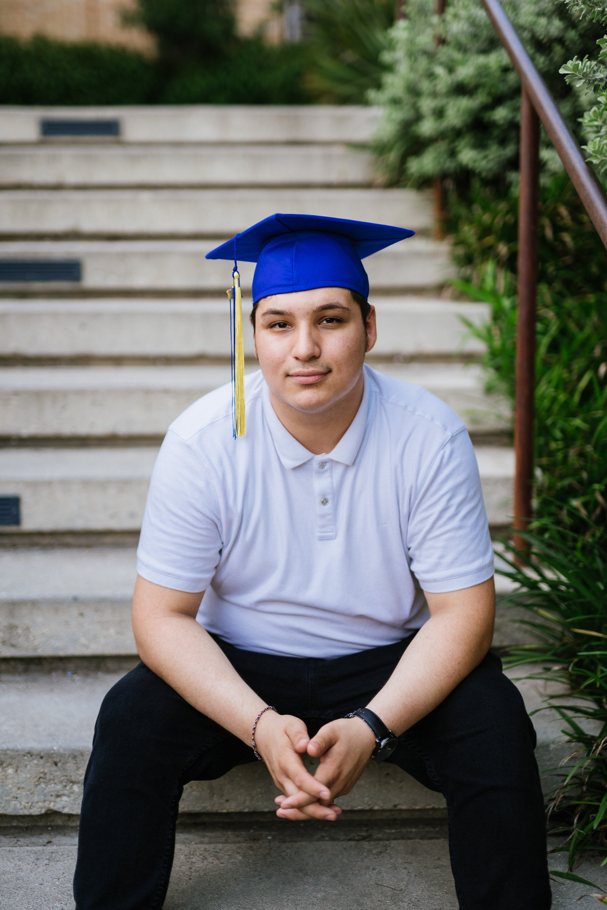 high school senior guy posing with cap and white shirt