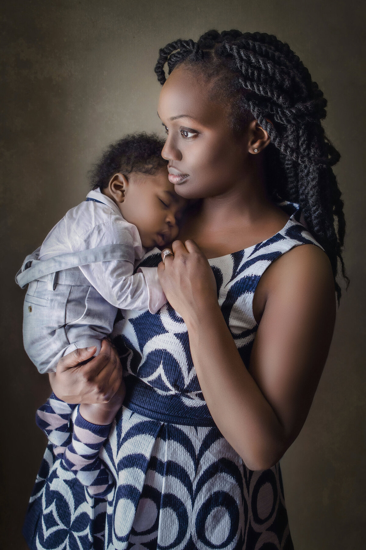 Mother holds her son for photos during her family photography shoot at NJ photo studio.