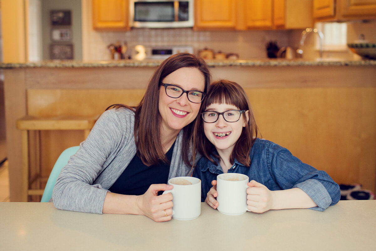 Mom and daughter enjoy a cup of hot chocolate after snow time outside!
