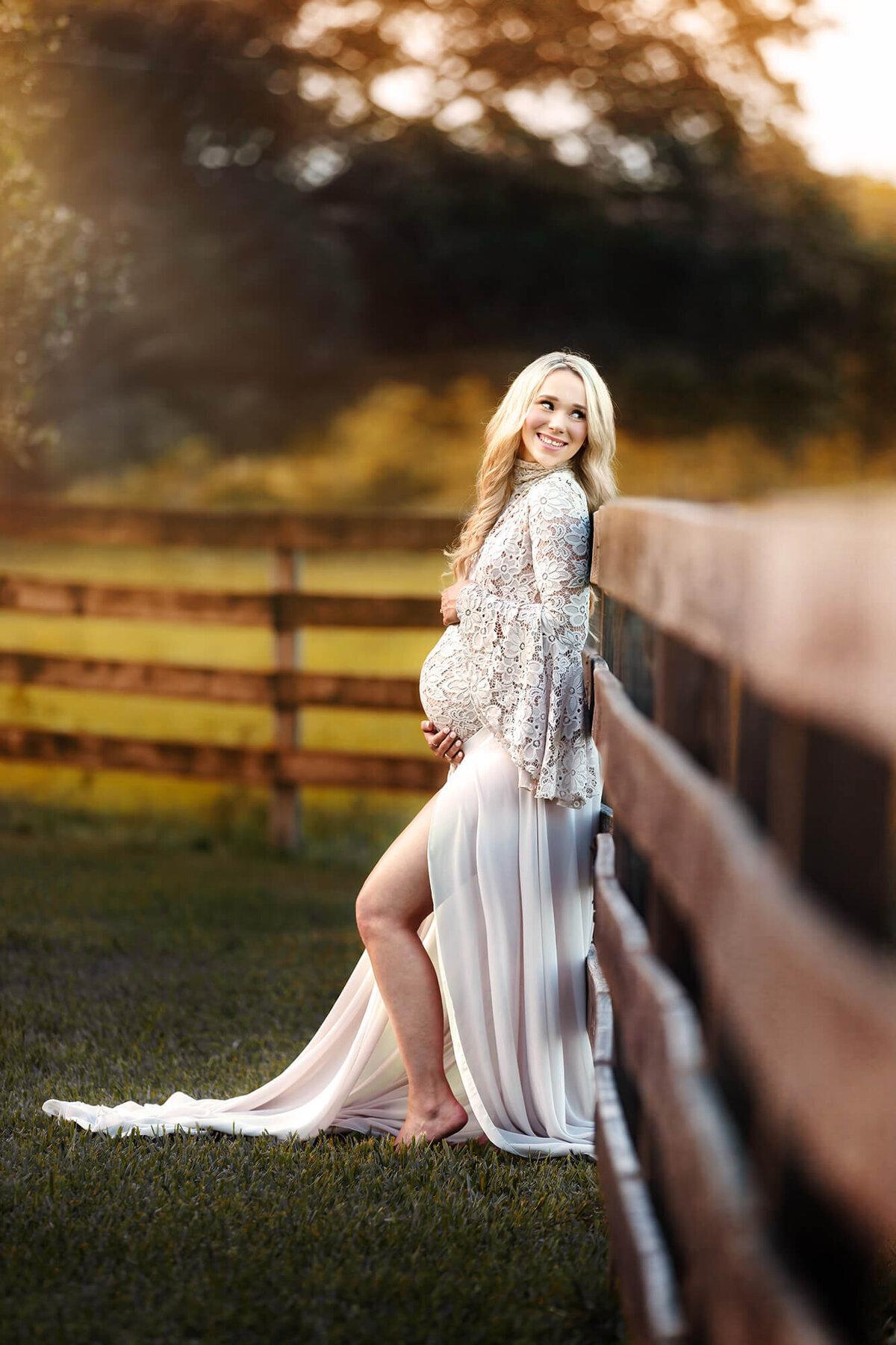 Lovely pregnant lady wearing a neutral colored lace dress in angleton, Texas during her maternity photography session.