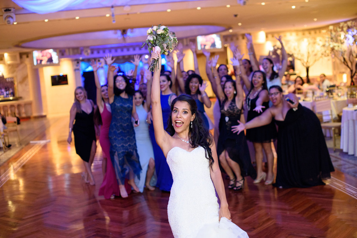 Bride throwing the bouquet at The Sands
