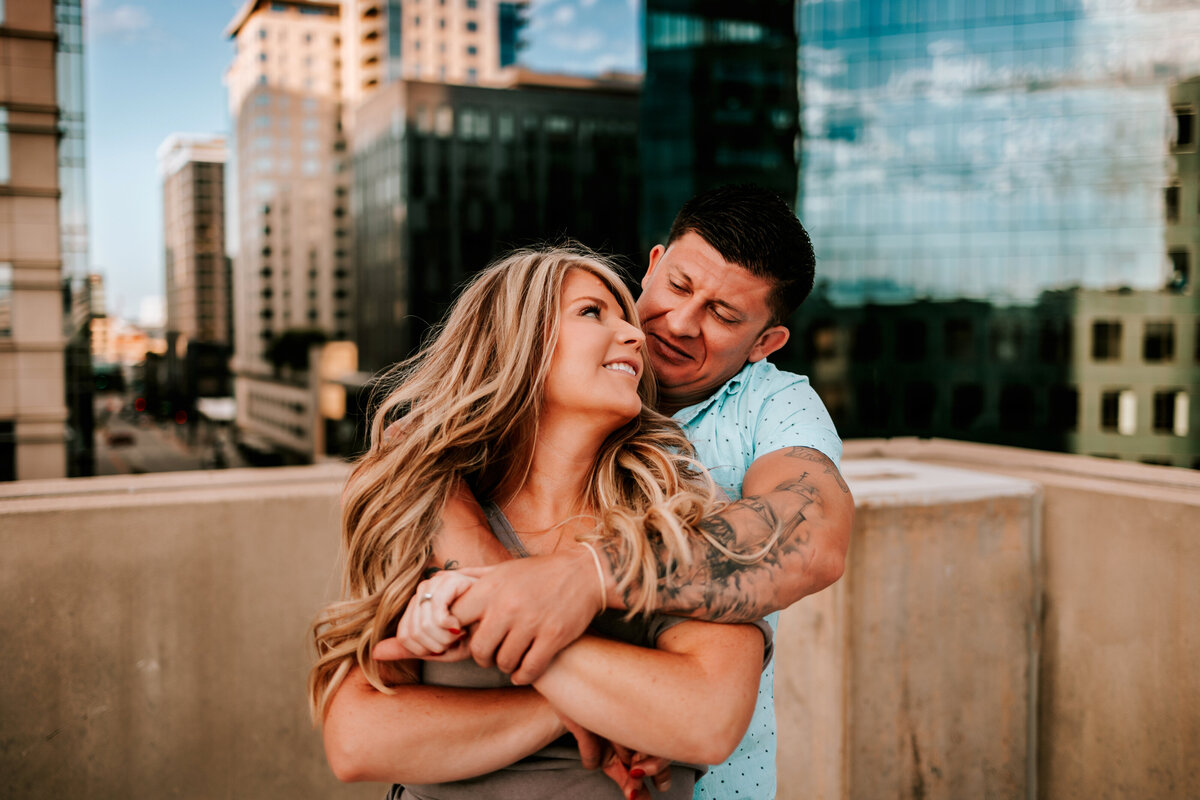 colorado hug each other on rooftop in downtown denver rooftop for couples session