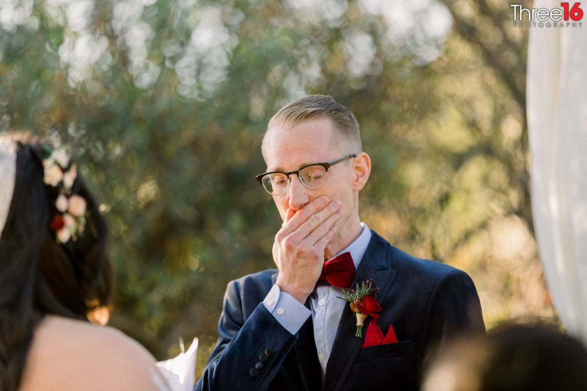 Groom holds it together during the wedding ceremony
