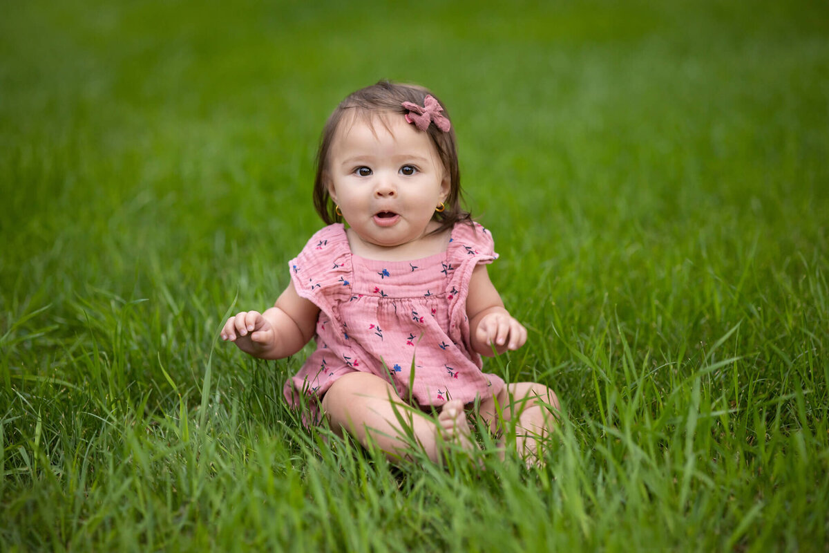 young child sitting in the grass