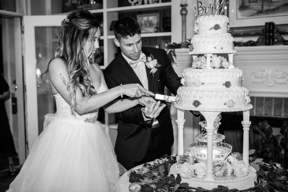 husband and wife cutting cake at their wedding in savannah