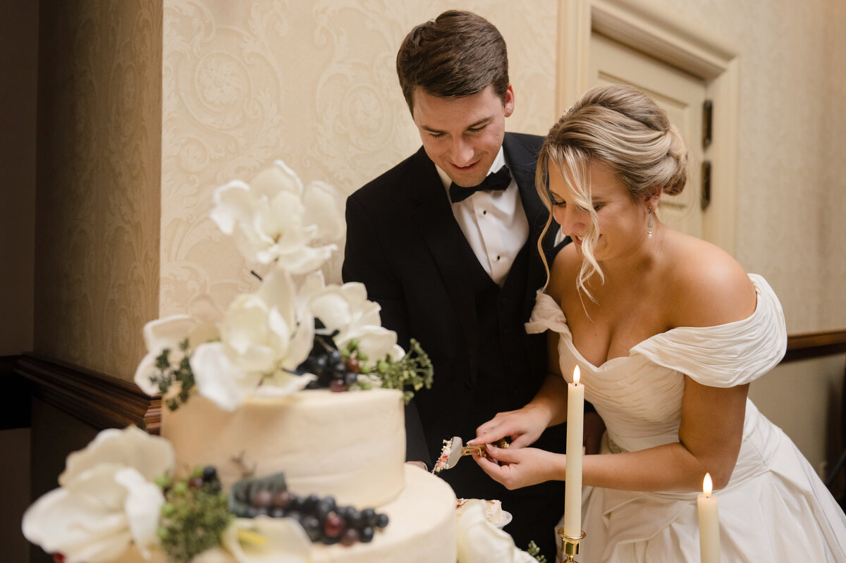 bride and groom cut cake