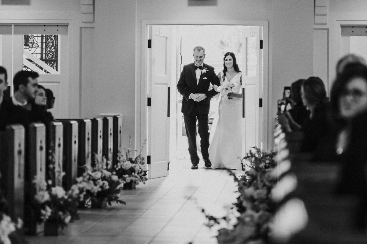 Classic and Timeless Bride walks down the Aisle at the Church during a Luxury Michigan Lakefront Golf Club Wedding.