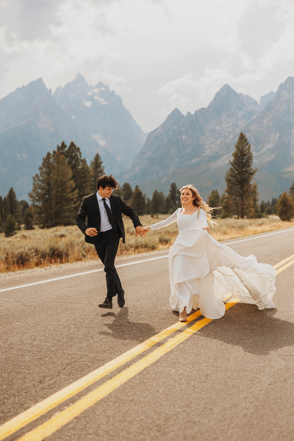 bride and groom running in road