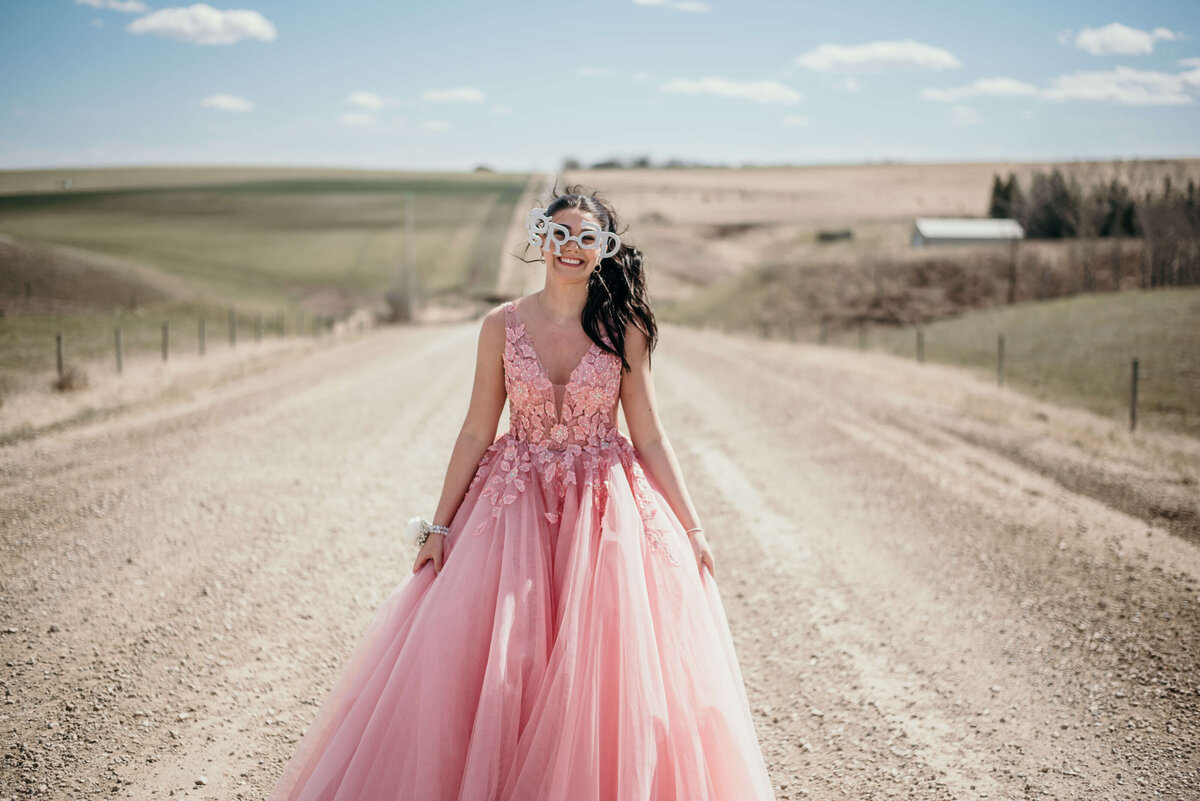 Girl in pink tulle dress on road