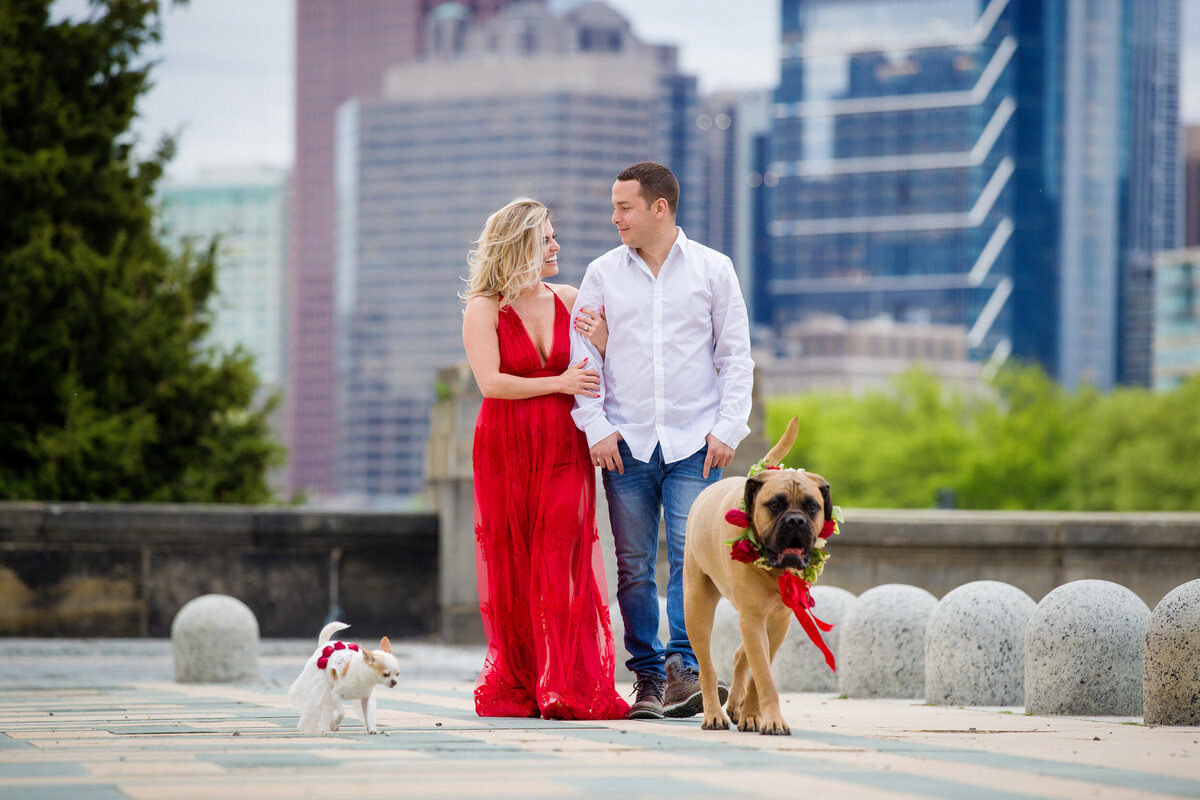 engaged couple walks with their two dogs at their Philadelphia engagement session