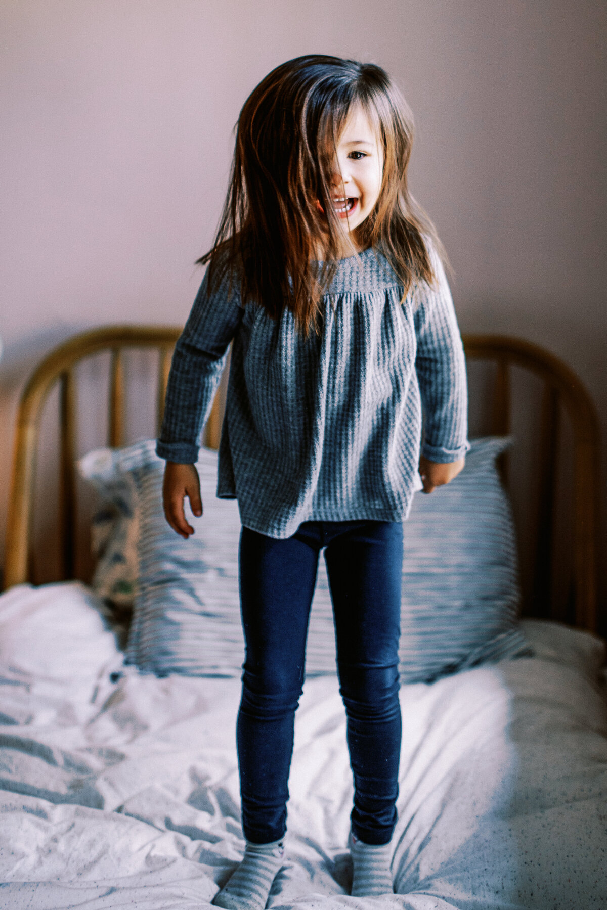 daughter jumping on bed