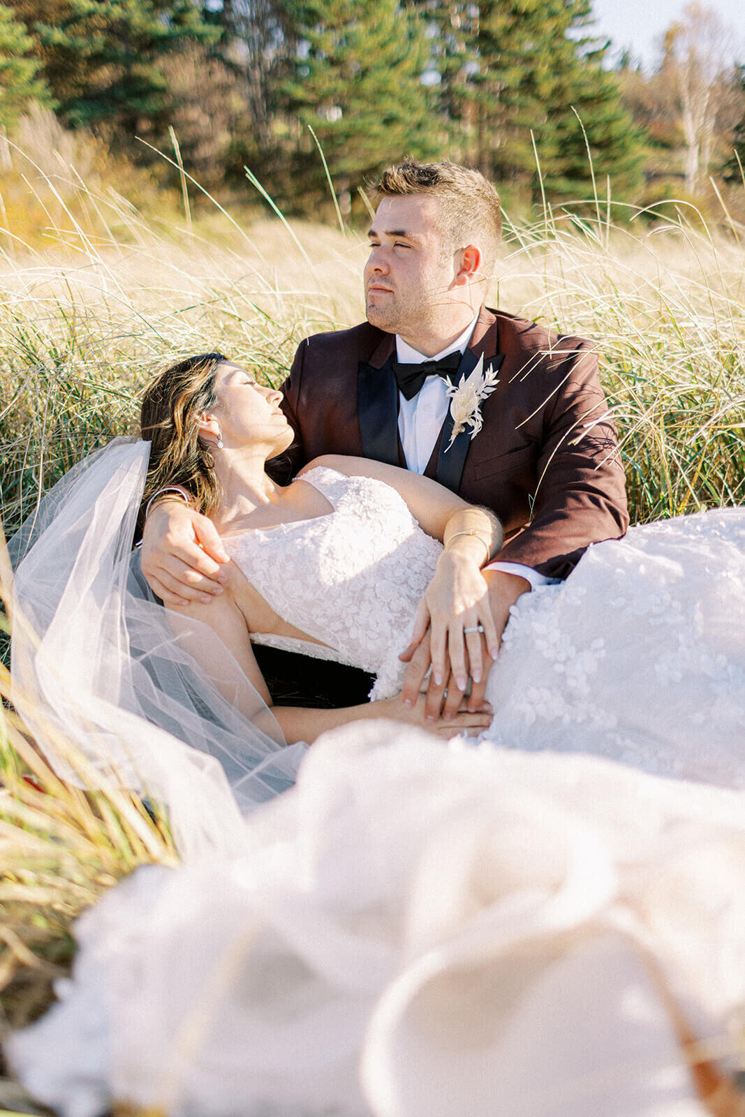 bride-and-groom-lay-in-grass