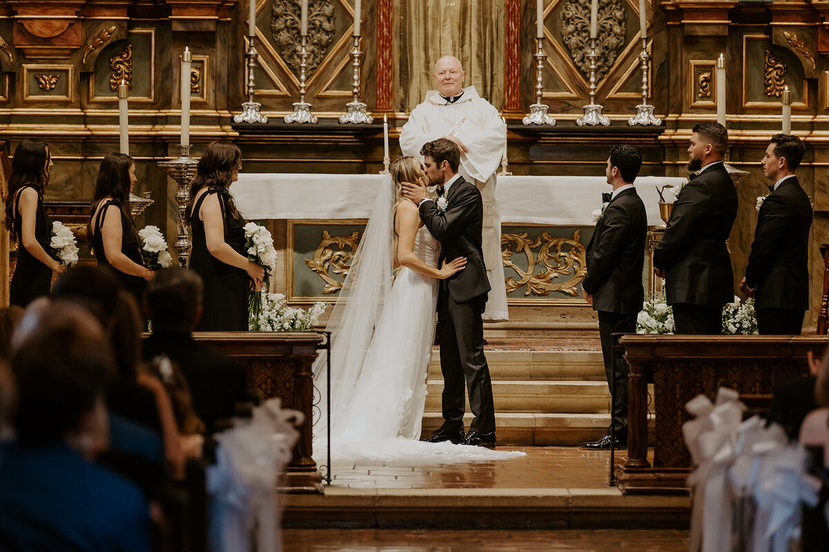 Couple Kissing at the the Alter at the Carmel Misison