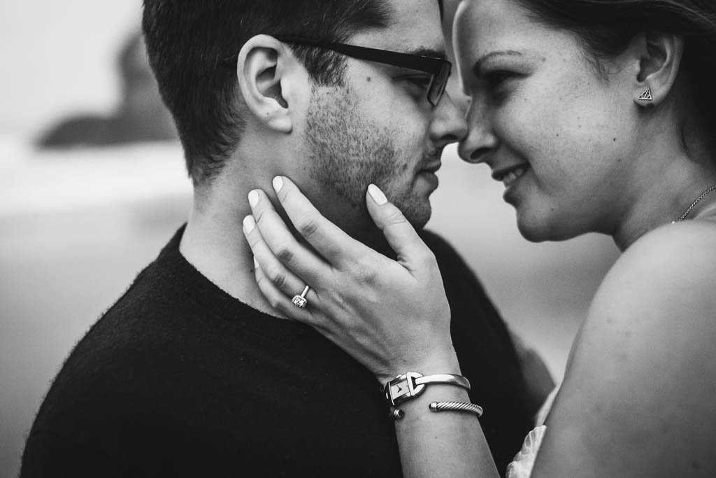 Bay Area engagement session.  Couple stands nose to nose with fiancee's hand on partner's cheek