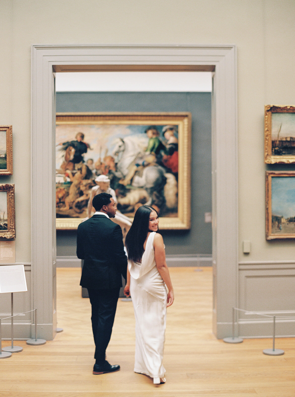 cute couple walking the halls of a museum at the MET in manhattan, engagement session at the MET
