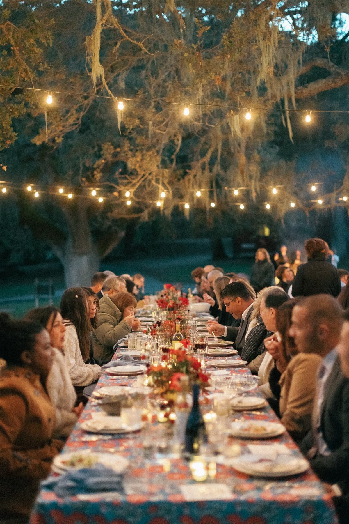 Carmel Long table wedding dinner red centerpieces