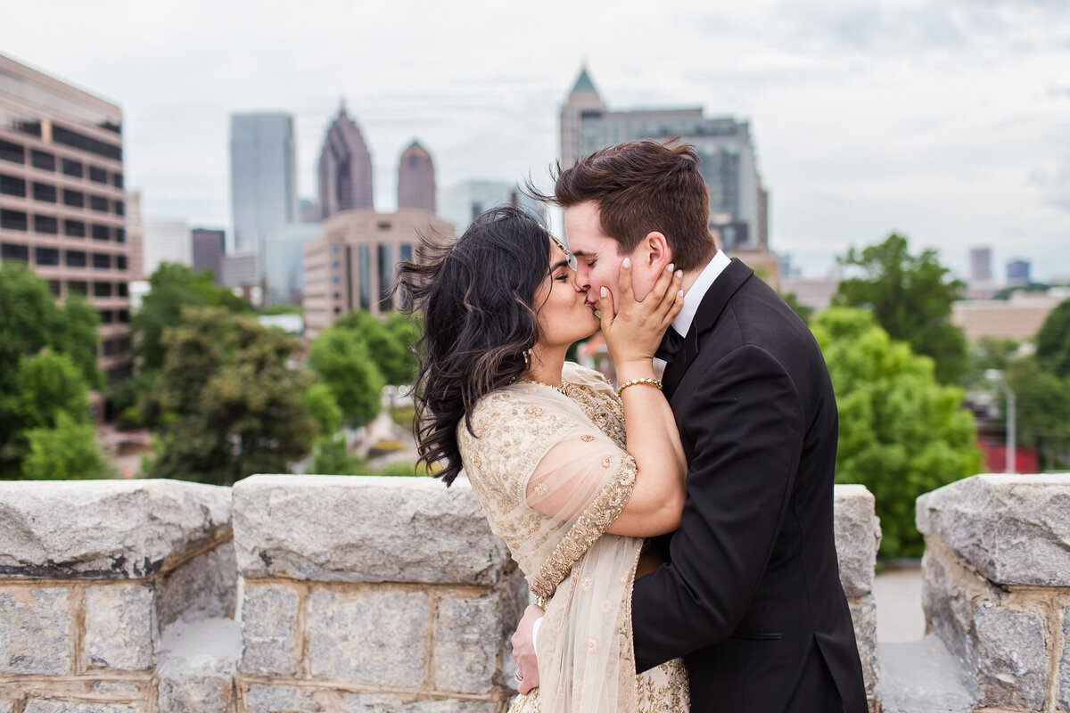 interracial wedding couple on a rooftop in atlanta georgia with city skyline in background