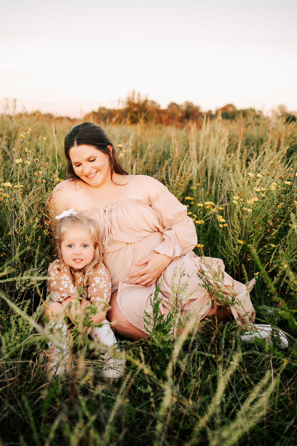 maternity photo in Springfield Mo of pregnant mom watching smiling toddler