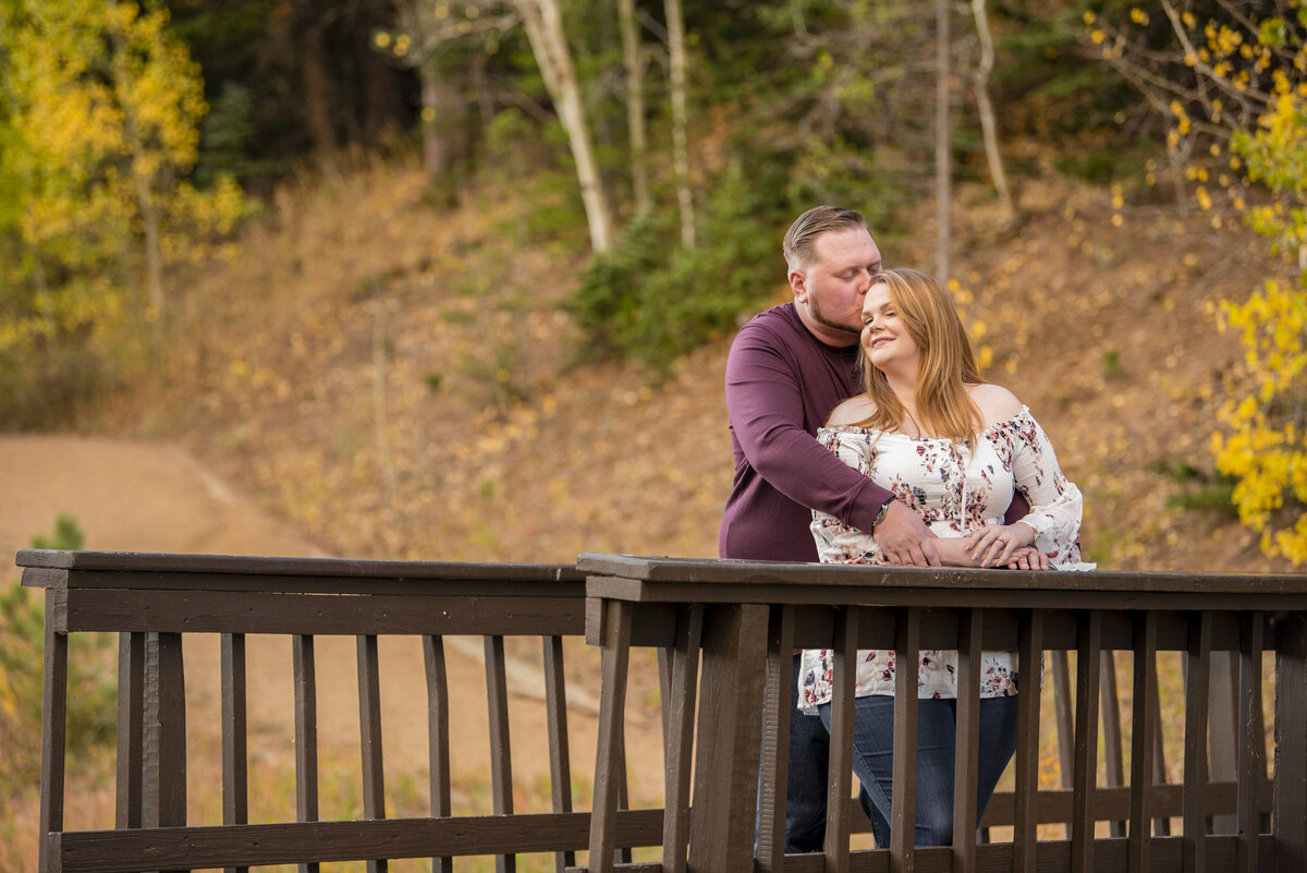 Engagement session in Golden on a bridge with september wedding during fall and golden leaves