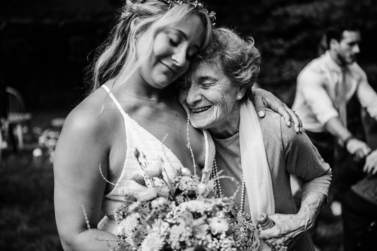 bride shares a hug from grandma at her backyard ct wedding