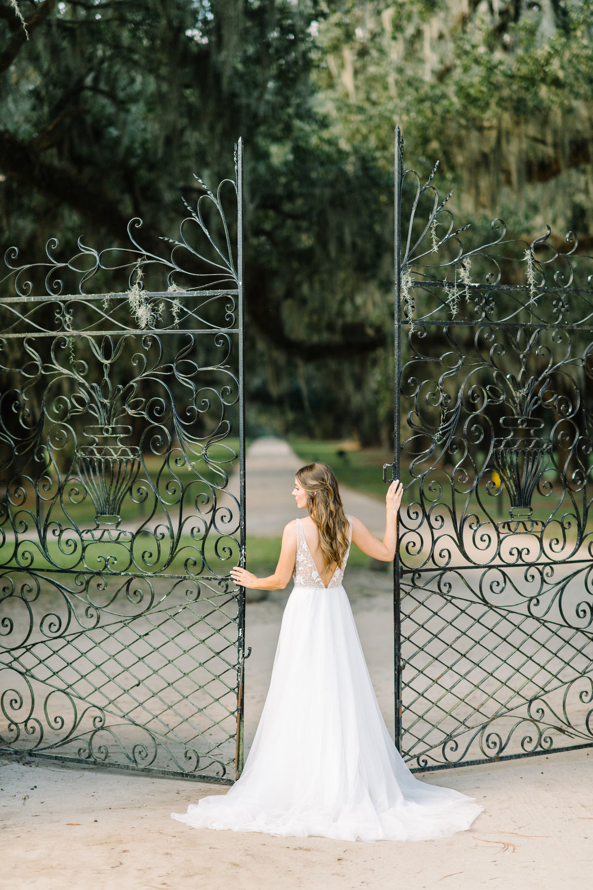 Bride standing at Boone Hall Planation Iron Gates