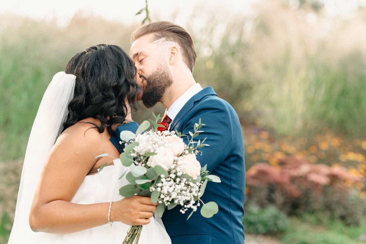 Okanagan Wedding Photographer- bride and groom kiss in a park