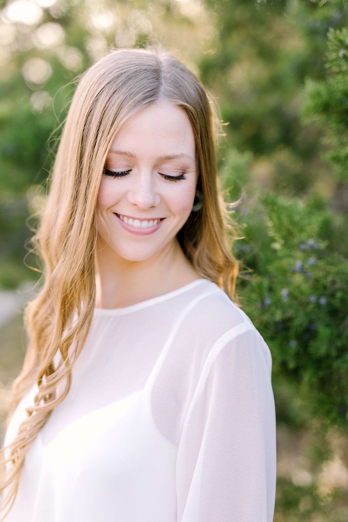 Woman dressed in white dress for engagement session