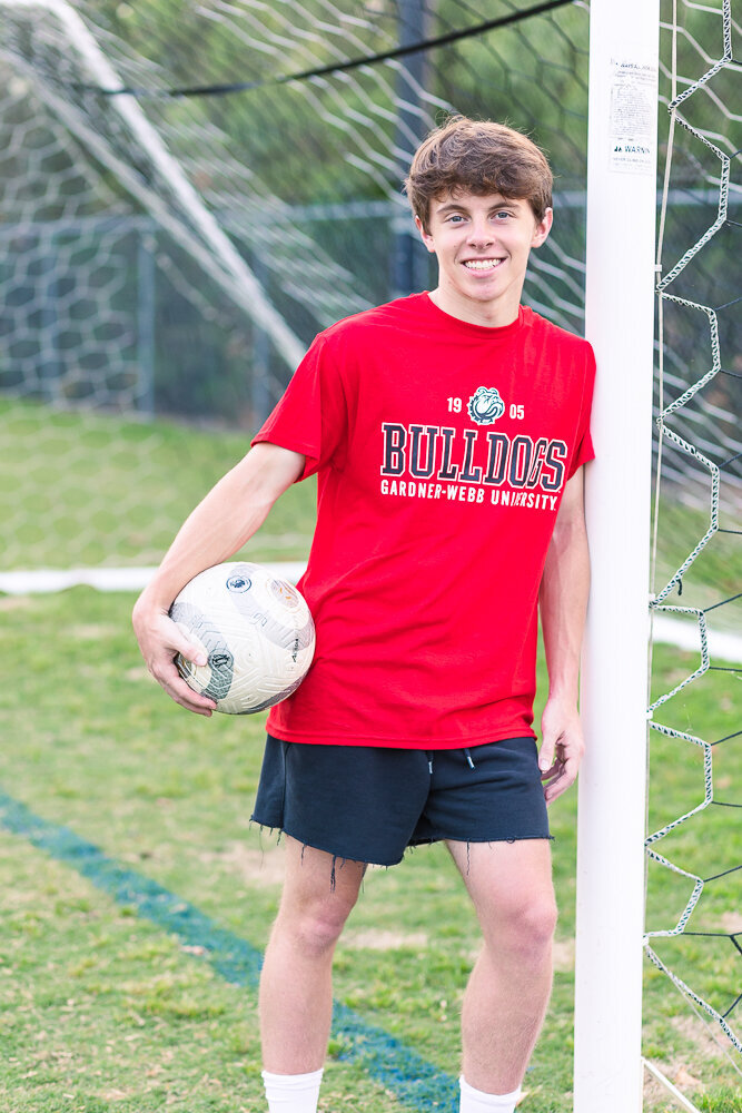 High school senior portrait session at North Raleigh Christian Academy soccer field.