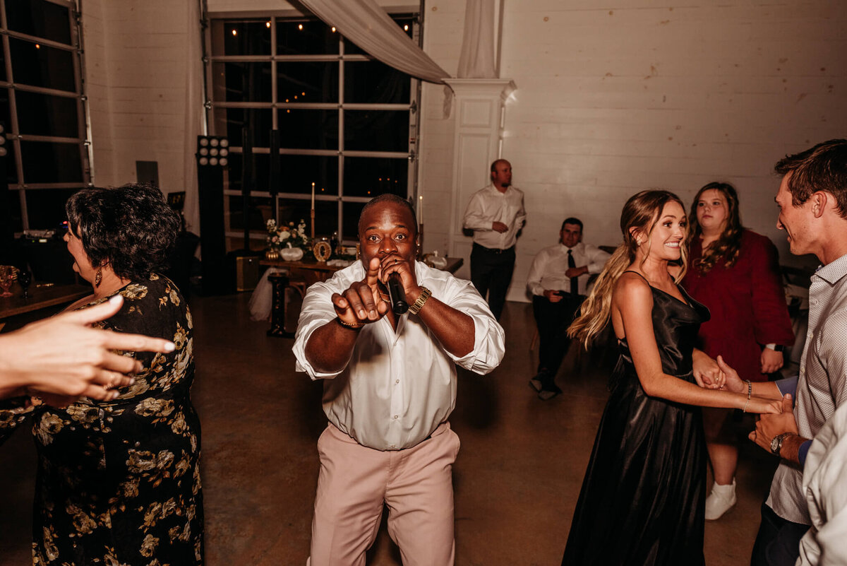 Photo of a Tennessee wedding DJ singing into the microphone