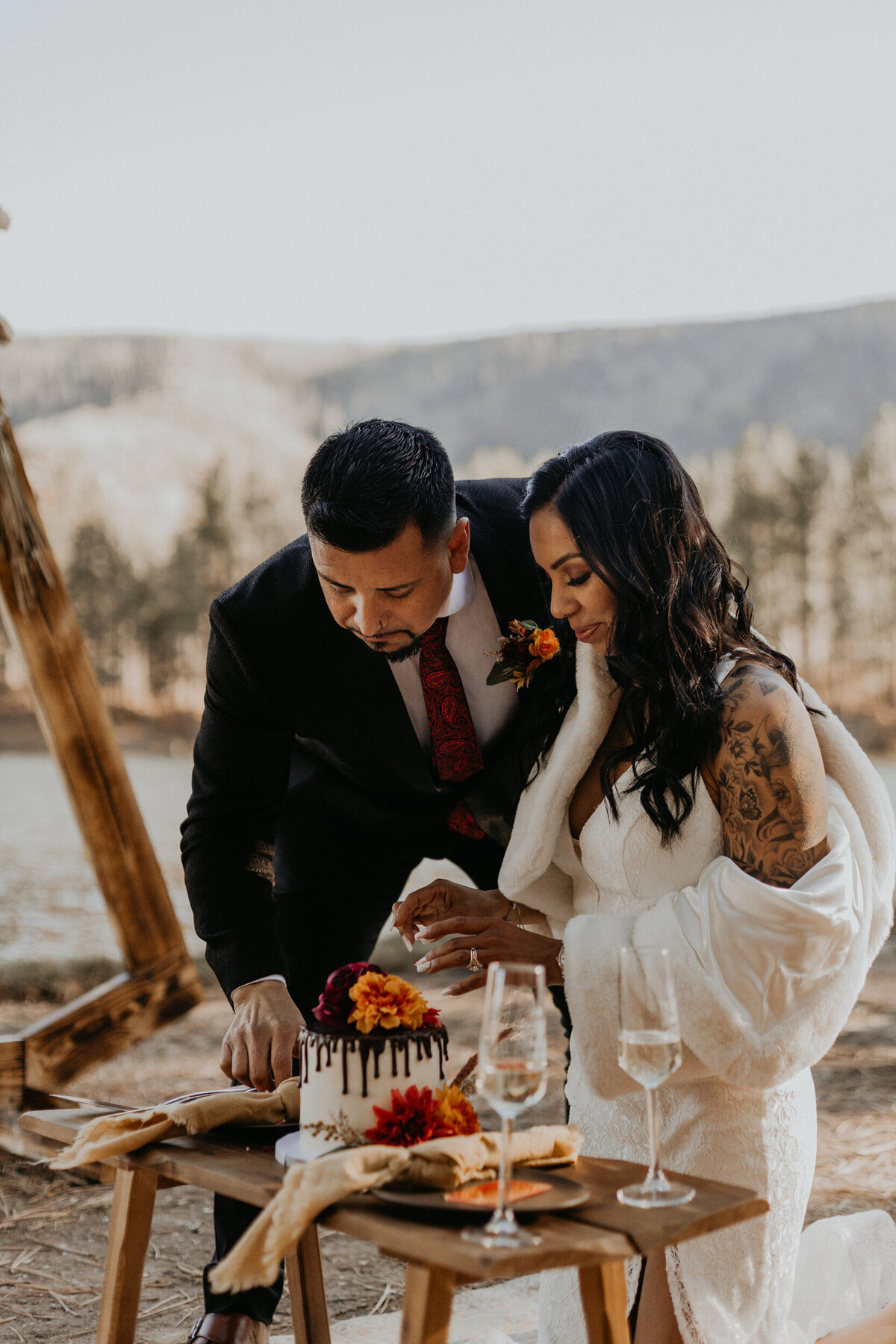 newlyweds cutting cake after their elopement ceremony