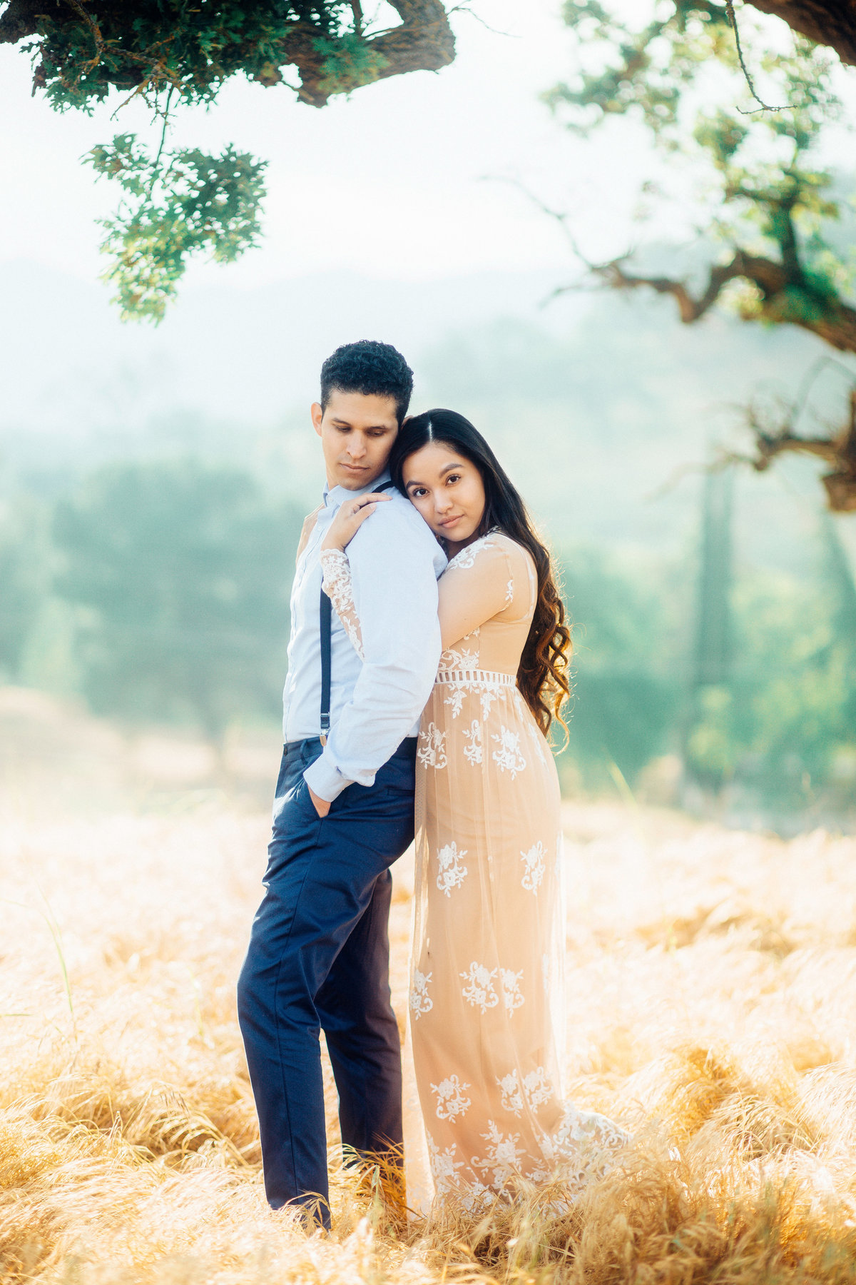 Engagement Photograph Of  Woman In Dress Hugging a Man From The Back Los Angeles