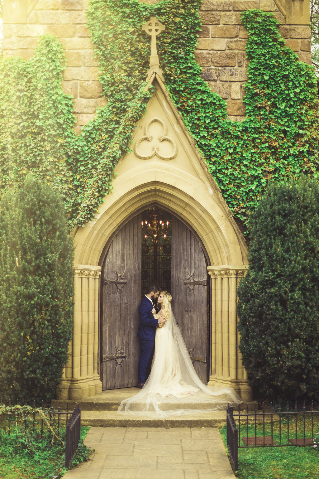 Wedding Photograph Of Bride and Groom Kissing at the Door of Church Los Angeles