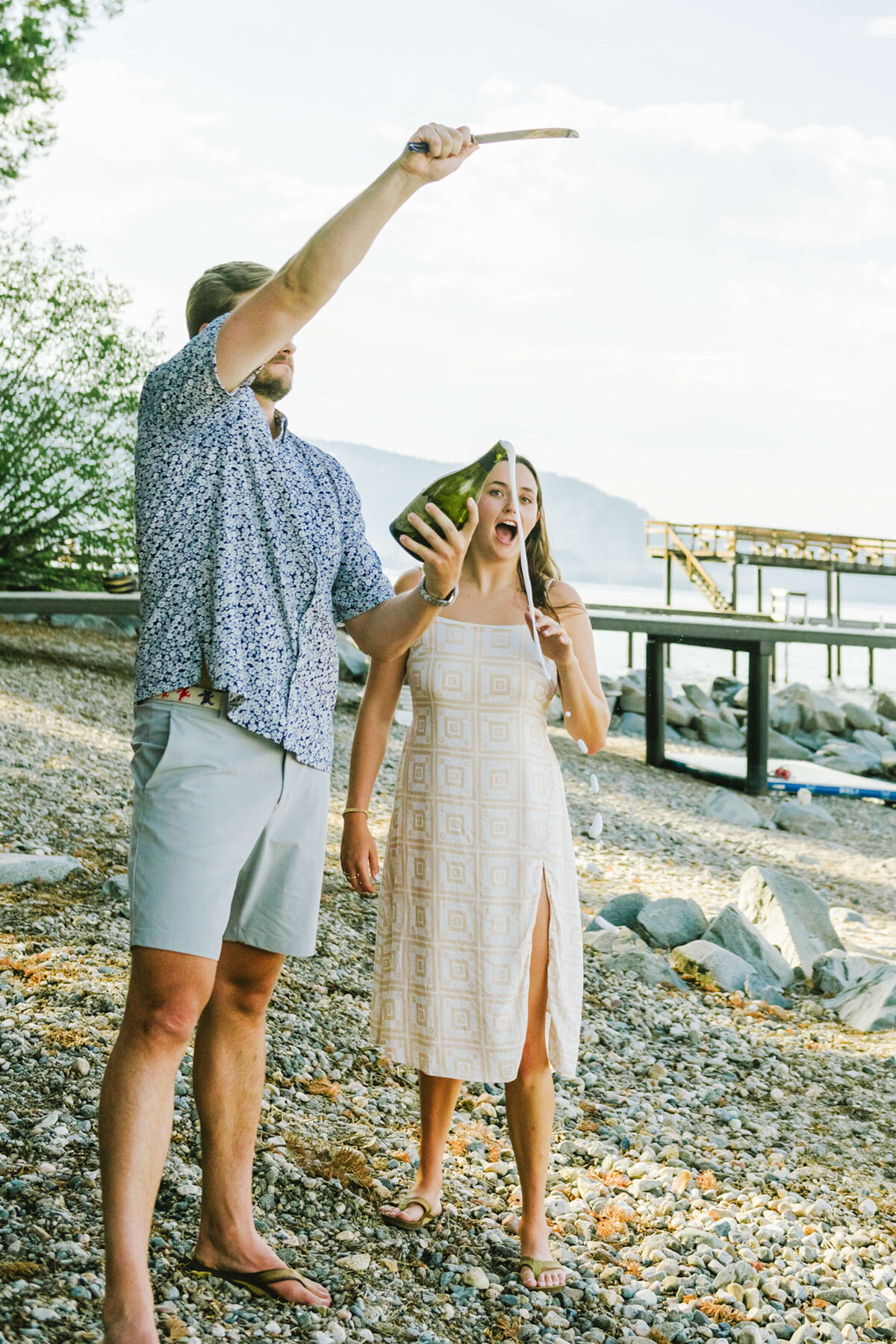 just engaged champagne opening bottle on the beach in lake tahoe private residence