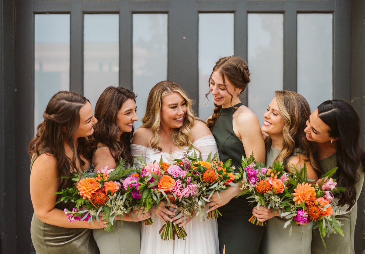 Bride with bridesmaids in green dresses at the St Vrain, Boulder county wedding venue