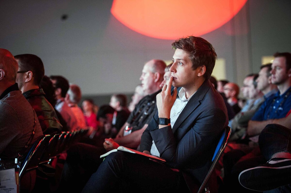 An interested attendee takes notes attentively in breakout session