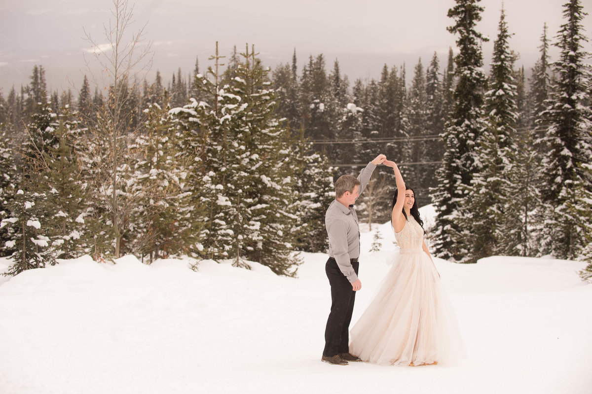 Beautiful Big White ski hill resort engagement photos in the snow while snowing