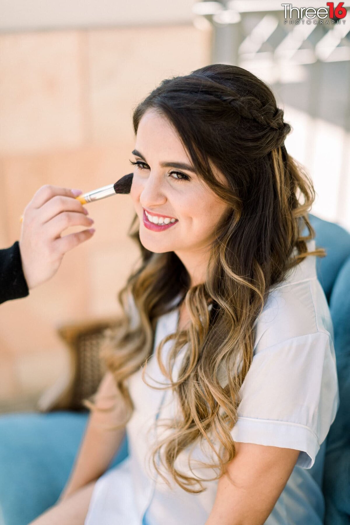 Bride getting her final makeup touch up prior to the wedding