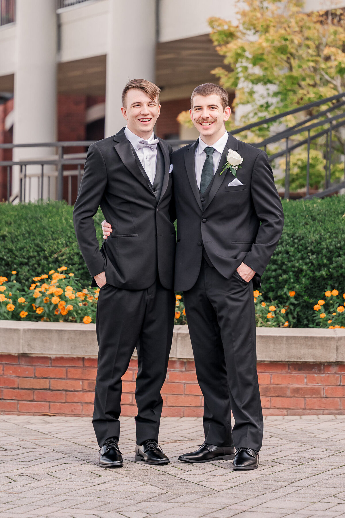 A groom and his groomsmen in a pavillion after his wedding ceremony by JoLynn Photography