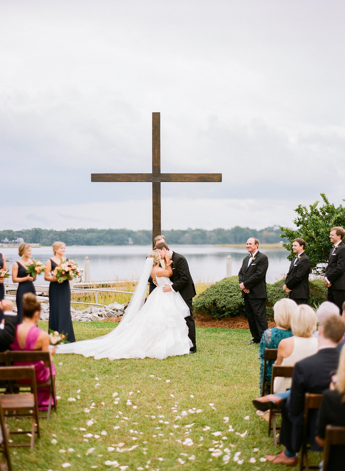 Charleston Wedding Ceremony with Mahogany Cross Waterfront Views Bride and Groom First Kiss