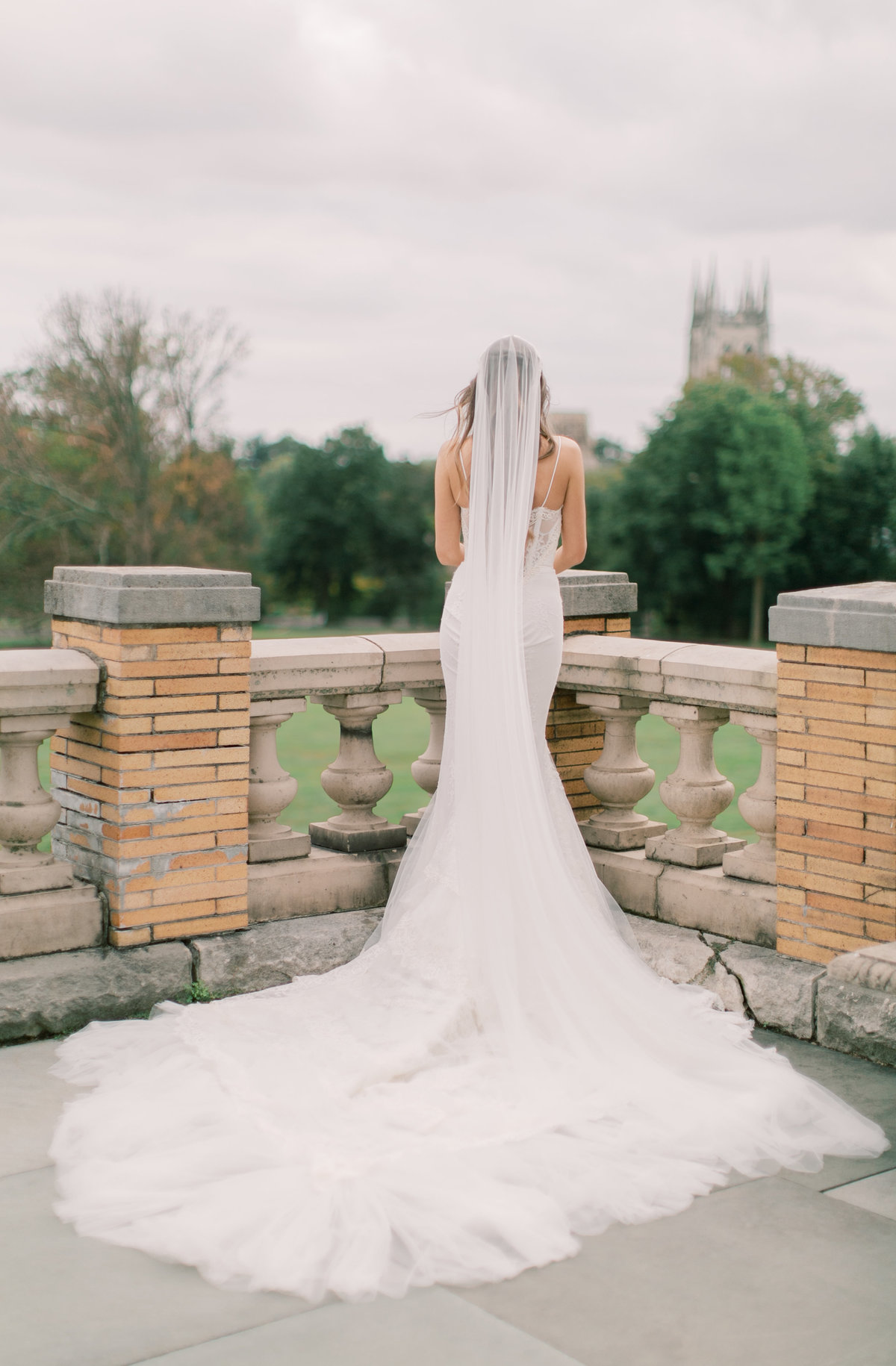bride overlooking wedding venue in philadelphia wearing strapless wedding gown